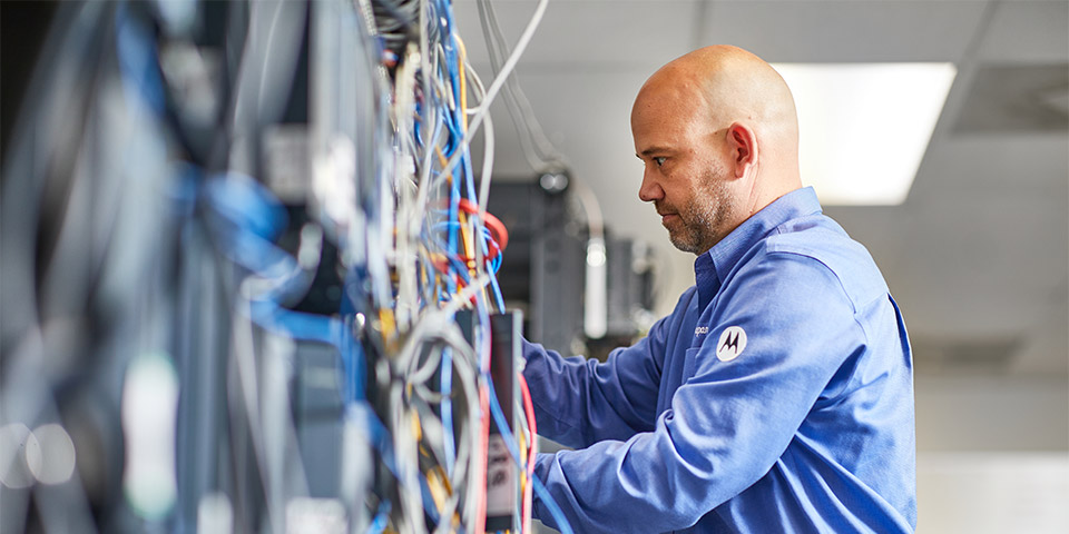 Male employee of Lord & Company adjusting a piece of automation equipment